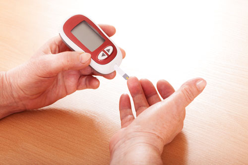 Person taking their blood pressure from their finger.