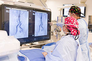 Photograph of Surgeons Viewing Results from an Imaging Scan