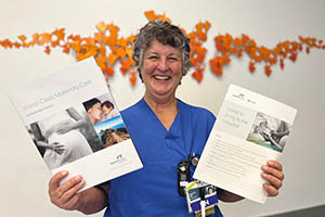 Photograph of a Nurse on the Maternity Unit holding flyers
